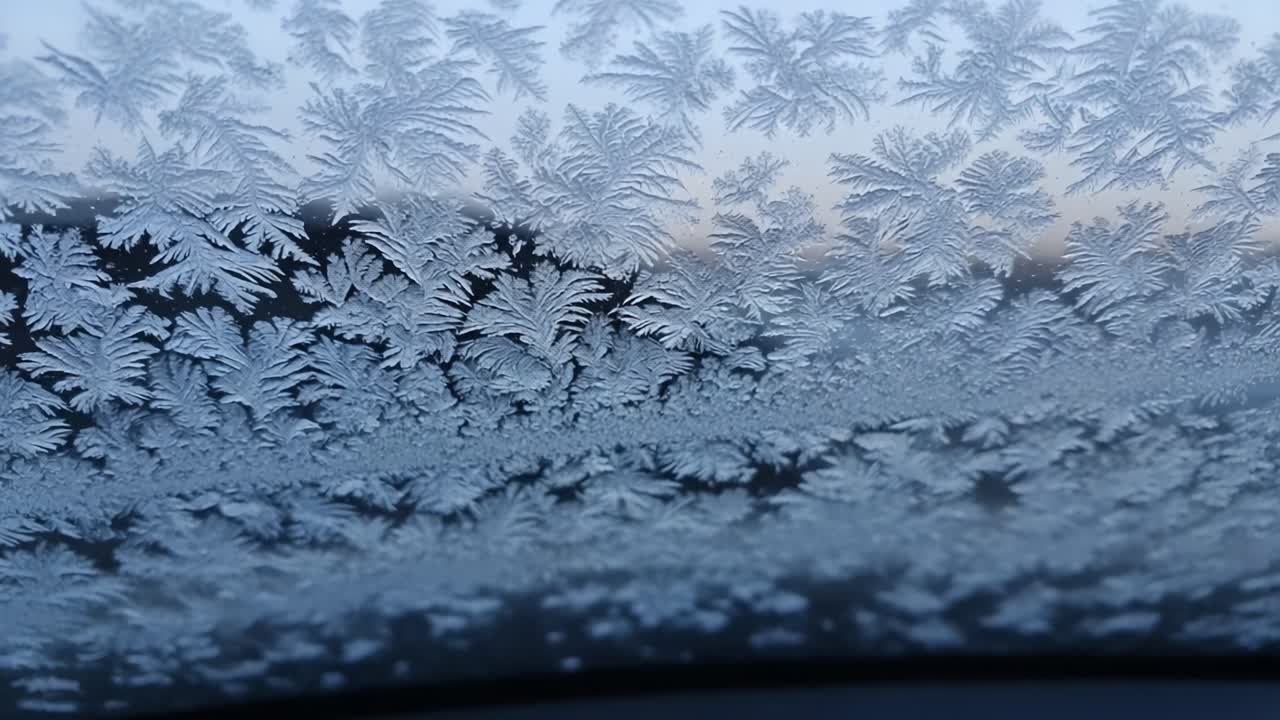 Delicate frost patterns on a windshield create a mesmerizing natural artwork, revealing intricate designs that reflect the beauty of winter mornings and the chill in the air