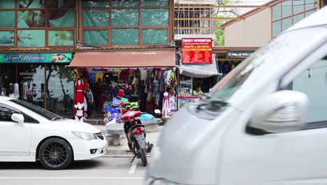 busy street scene with vehicles and shops