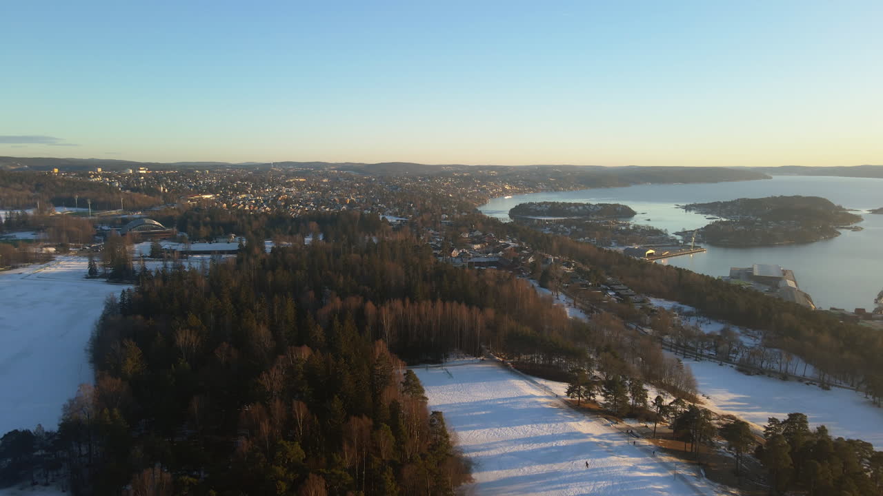 Panoramic drone shot of the east side of Oslo, Norway on a bright sunny day in the winter