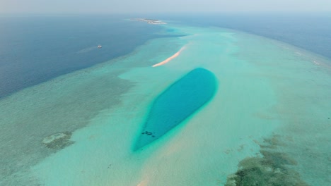 an awe-inspiring aerial drone view captures the rasdhoo sandbanks glowing under the soft, golden light of sunset in the maldives.