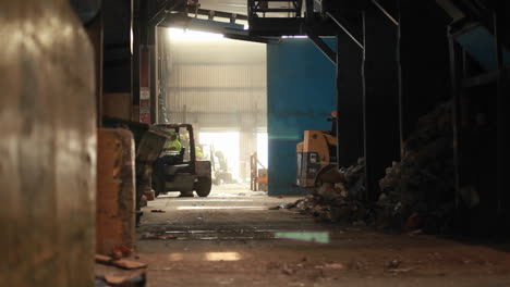 a skip loader picks up trash at a recycling center 1