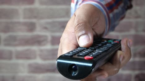 person using a tv remote control