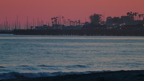 Santa Barbara Pier at Sunset with Silhouetted Boats and Palm Trees