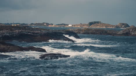 powerful waves are crashing on the rocky shores near the atlantic road, in norway