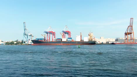 red hook terminal seen from governors island, large shipping container, day