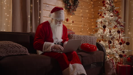 zoom camera santa answers emails browses the internet bank and works at a laptop