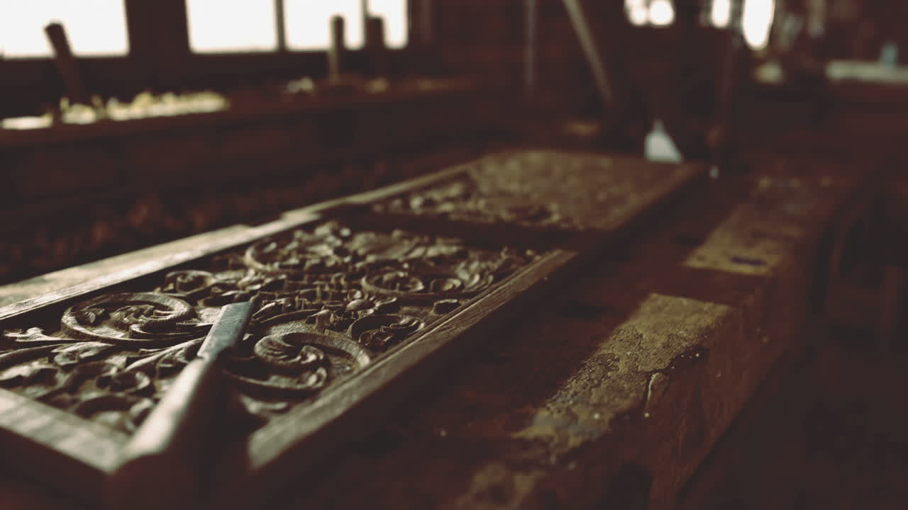 Intricate wood carving process captured in a workshop during twilight hours