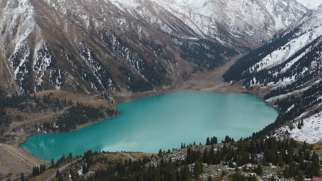 cinematic rotating drone shot of the big almaty lake in the trans-ili alatau mountains in kazakhstan