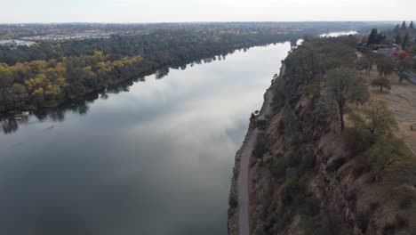 high traveling drone footage along the water with the sky reflecting off the waters surface