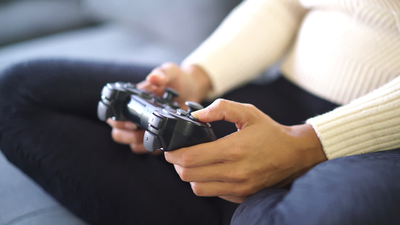 close-up hand playing game with joystick