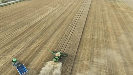 aerial view of combine harvesters harvesting wheat field