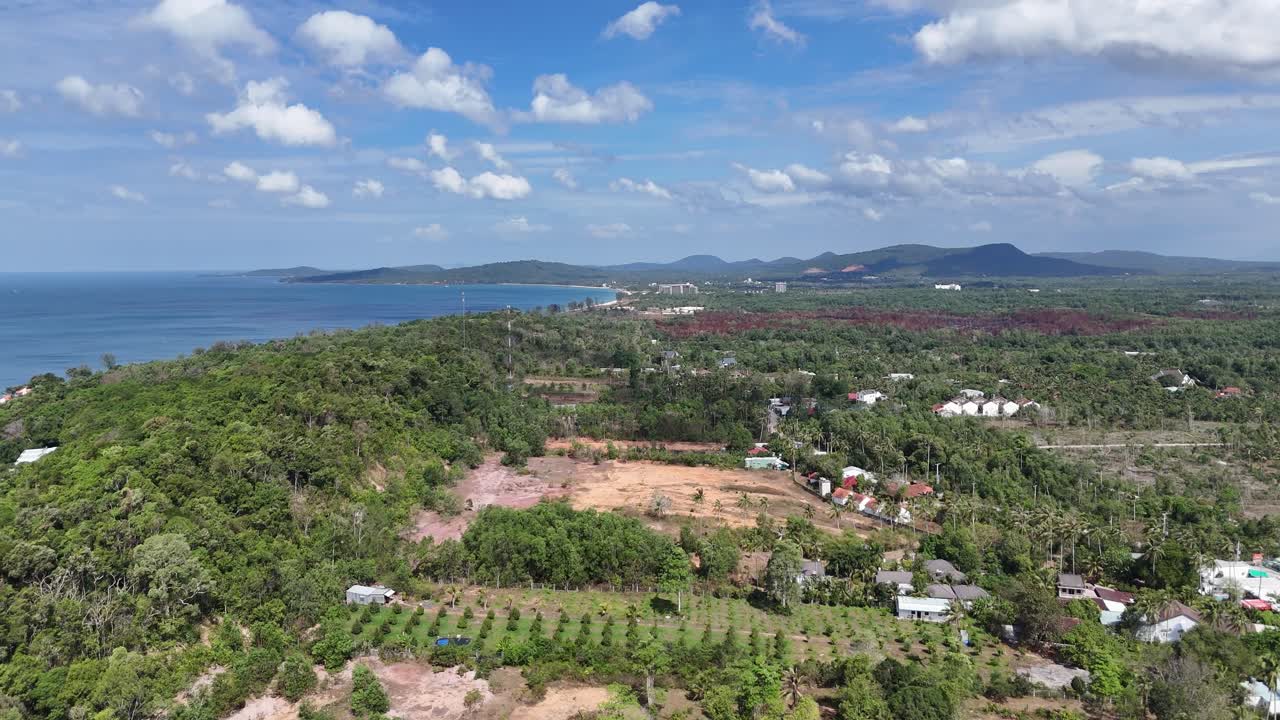 The aerial view captures a pristine expanse of sand and inviting waves, creating a tranquil and relaxing atmosphere perfect for a peaceful escape. white buildings , enhancing its visual appeal