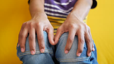 close-up of hands on knees