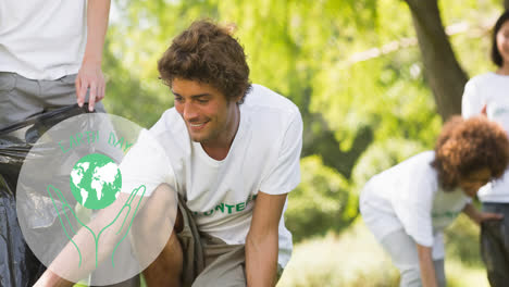 animation of earth day text with hands and globe logo over people doing cleaning work in forest