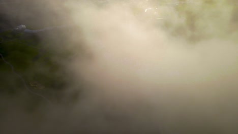 4k aerial view of torrey pines golf course through clouds