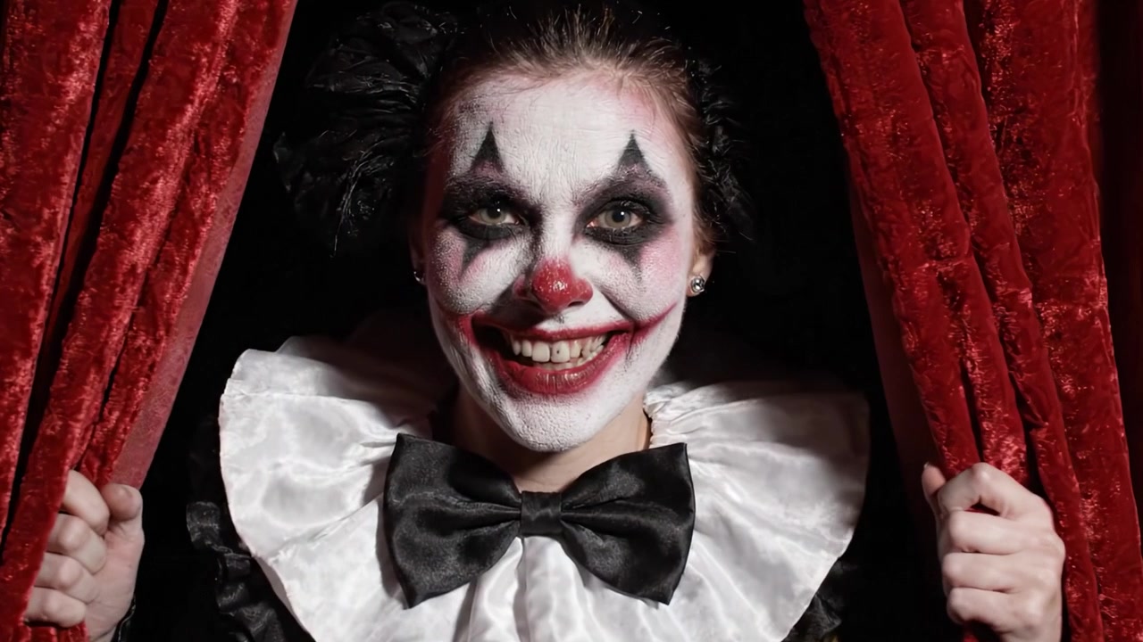 A Mysterious Clown Emerges from Rich Red Curtains, Blending Intrigue with Whimsy in a Striking Performance Setting Perfect for Captivating Audiences.