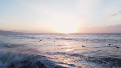 surfers at sunset, o'ahu north shore hawaii pacific ocean, 4k aerial view