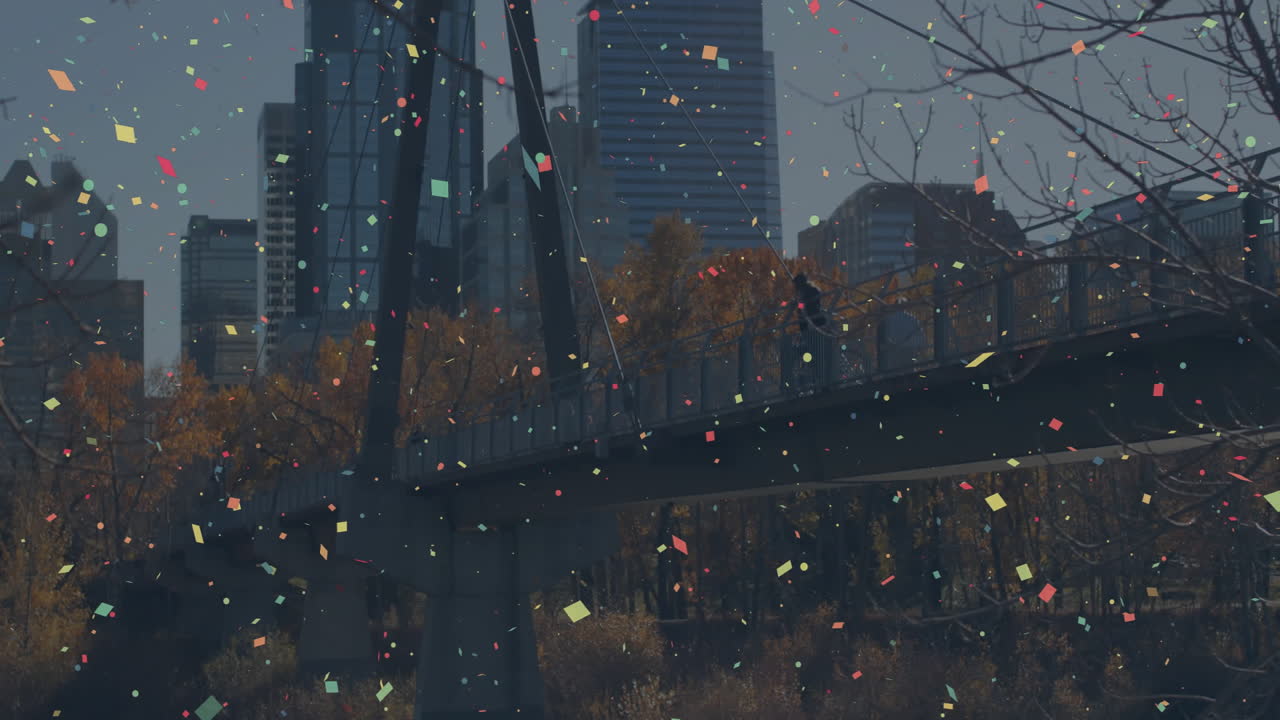 Confetti animation over people walking on bridge with city skyline in background