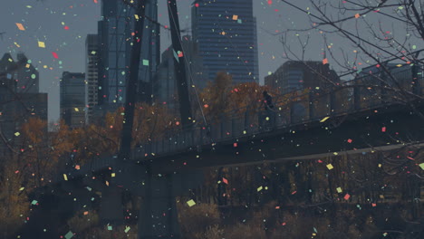 confetti animation over people walking on bridge with city skyline in background