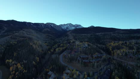 drone shot scaling up the mountainside of telluride resort ski runs in the fall