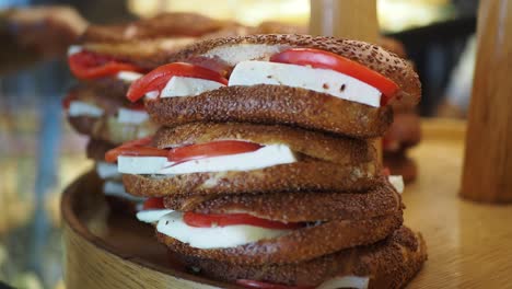 stack of simit sandwiches with cheese and tomato