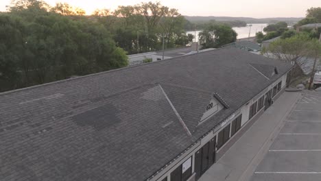 aerial view of a damaged roof on a commercial building with visible repair patches.