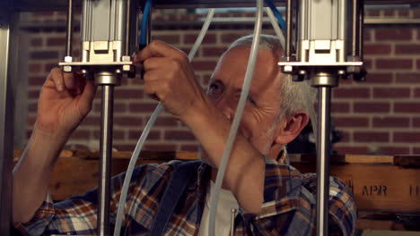 brewery worker checking the vats