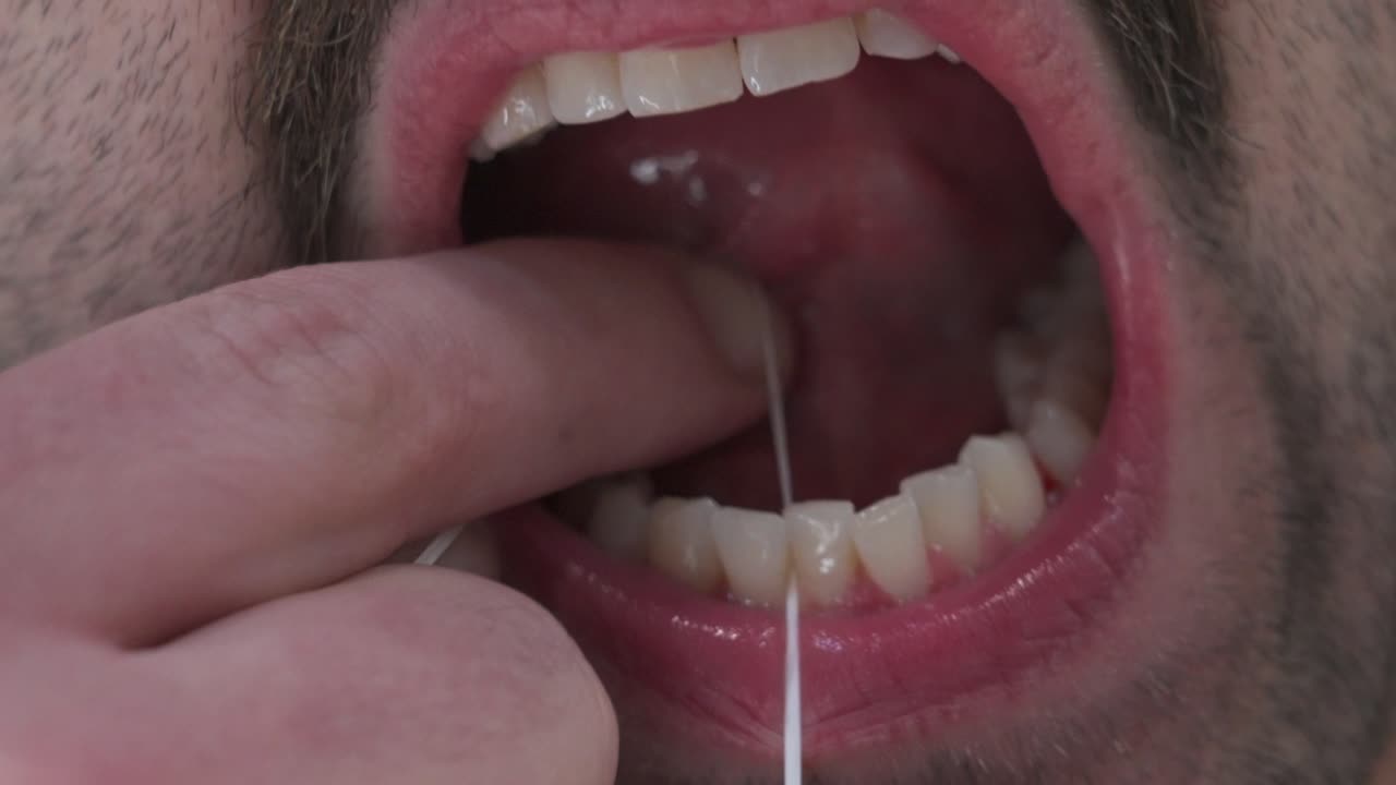 Flossing teeth as part of oral hygiene