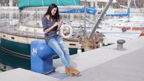 trendy young woman relaxing at a marine harbour