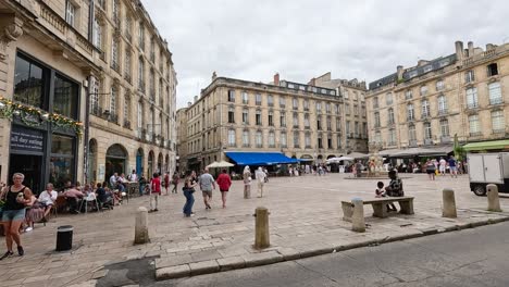 people walking and socializing in a city square