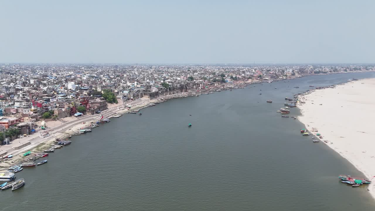 Overhead shot of Varanasi's vibrant riverside, where life moves in rhythm with the sacred Ganges, and ancient rituals blend with modern commerce.