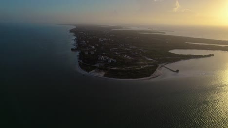 Sunset-aerial-over-Holbox,-an-island-in-the-Mexican-state-of-Quintana-Roo,-located-on-the-north-coast-of-the-Yucatán-Peninsula