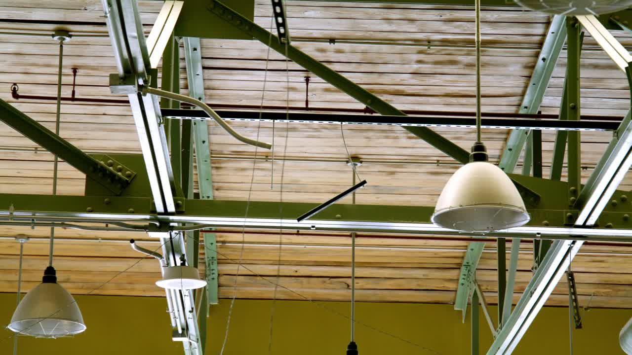 Industrial lighting in a warehouse with video dolly left to right close up.