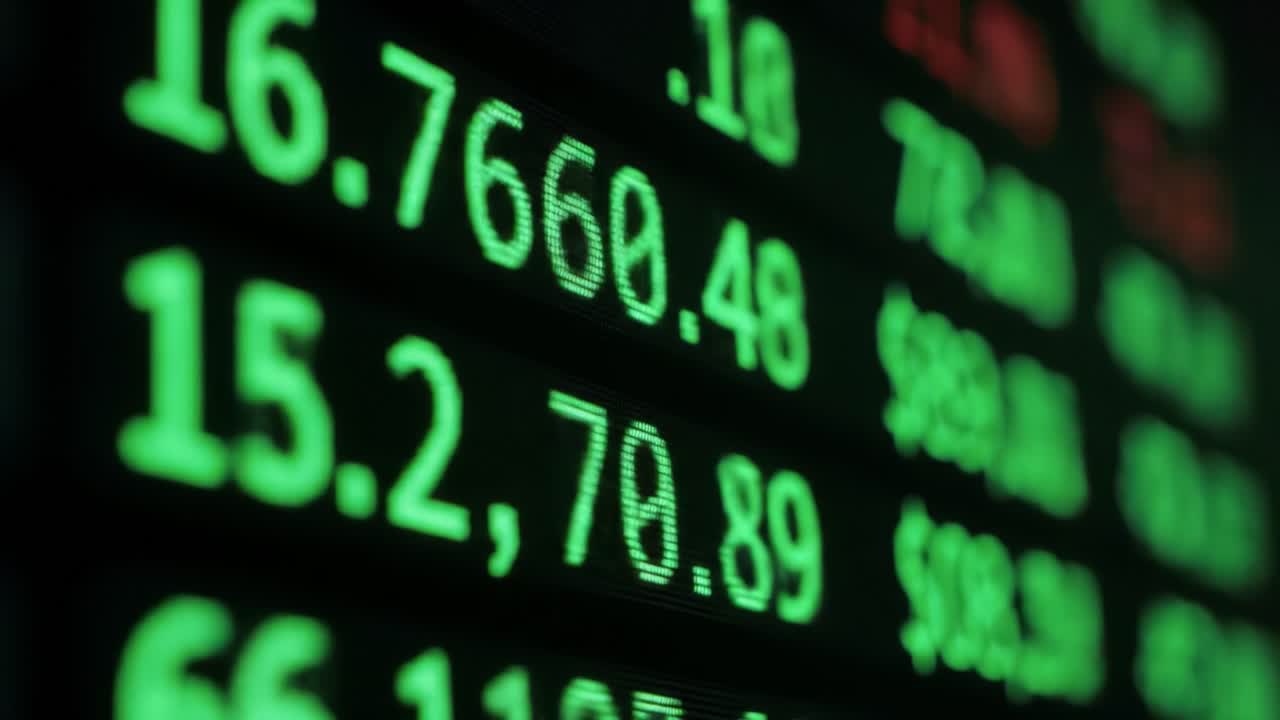 Stock exchange boards light up with changing numbers and percentages, showcasing market movements and volatility throughout the trading session capturing traders' attention.