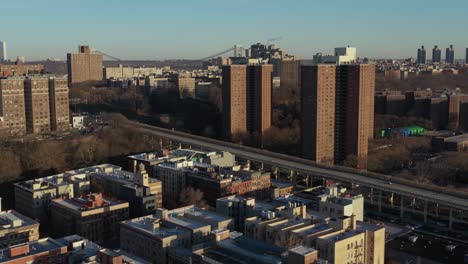 Aerial-trucking-shot-across-the-upper-end-of-the-Harlem-neighborhood-of-New-York-City-with-the-George-Washington-Bridge-far-in-the-background