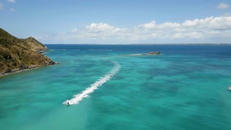 4K-Aerial-Drone-View-of-Person-Jet-Skiing-in-Turquoise-Blue-Water-in-Caribbean-Island-St-Maarten