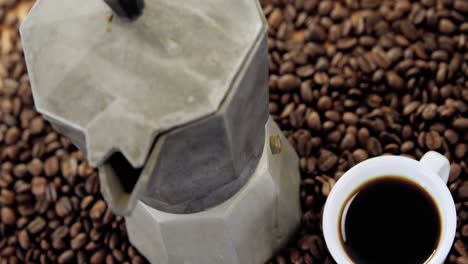 coffeemaker with coffee beans and coffee mug