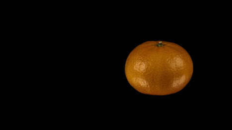 fruit: isolated orange revolves on right side of black background