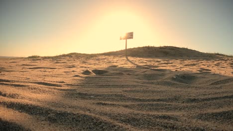 time lapse shot of golden beach and no lifeguard sign during sunset behind dunes - spanish sign in uruguay