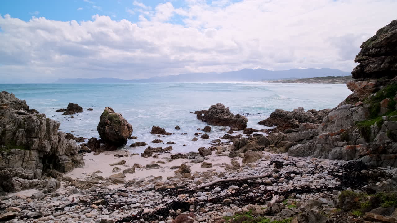 Scenic view over ocean from rocky Walker Bay reserve coastline toward Die Plaat