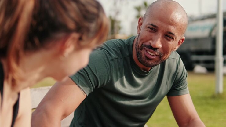 Active Couple Resting and Talking on a Park Bench