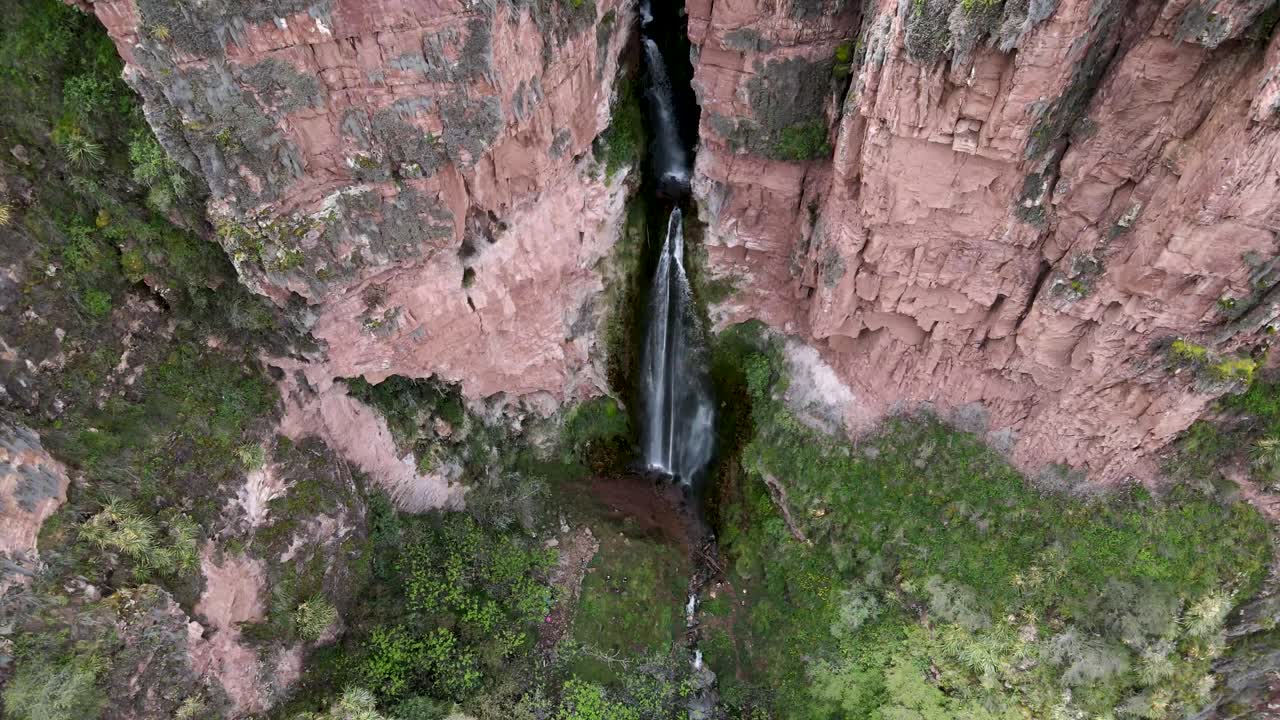 Aerial of the spectacular Perolniyoc Waterfall in Urubamba, Sacred Valley, Cusco, Peru. Drone tilt down