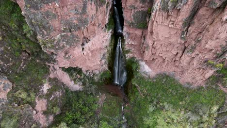 aerial of the spectacular perolniyoc waterfall in urubamba, sacred valley, cusco, peru. drone tilt down
