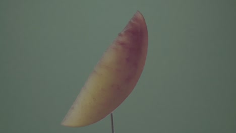 peach rotating with loop on green screen for chroma key