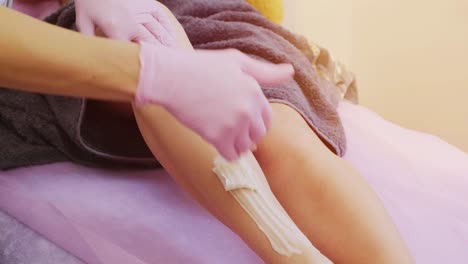 female legs depilation by honey or sugar pasta. sugaring hair removal. beauty concept. sugaring. epilation process. legs.