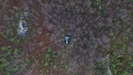 Vista-Aérea-Del-Tractor-Verde-Cortando-árboles-En-El-Bosque