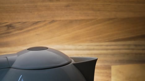 water prepare to boil in electric kettle in beautiful wooden background