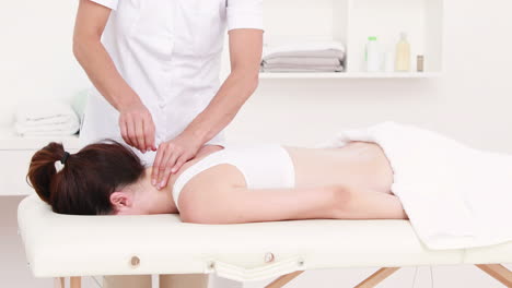 physiotherapist doing neck massage to her patient