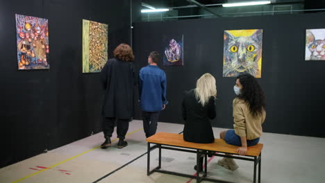 people viewing art in an art gallery