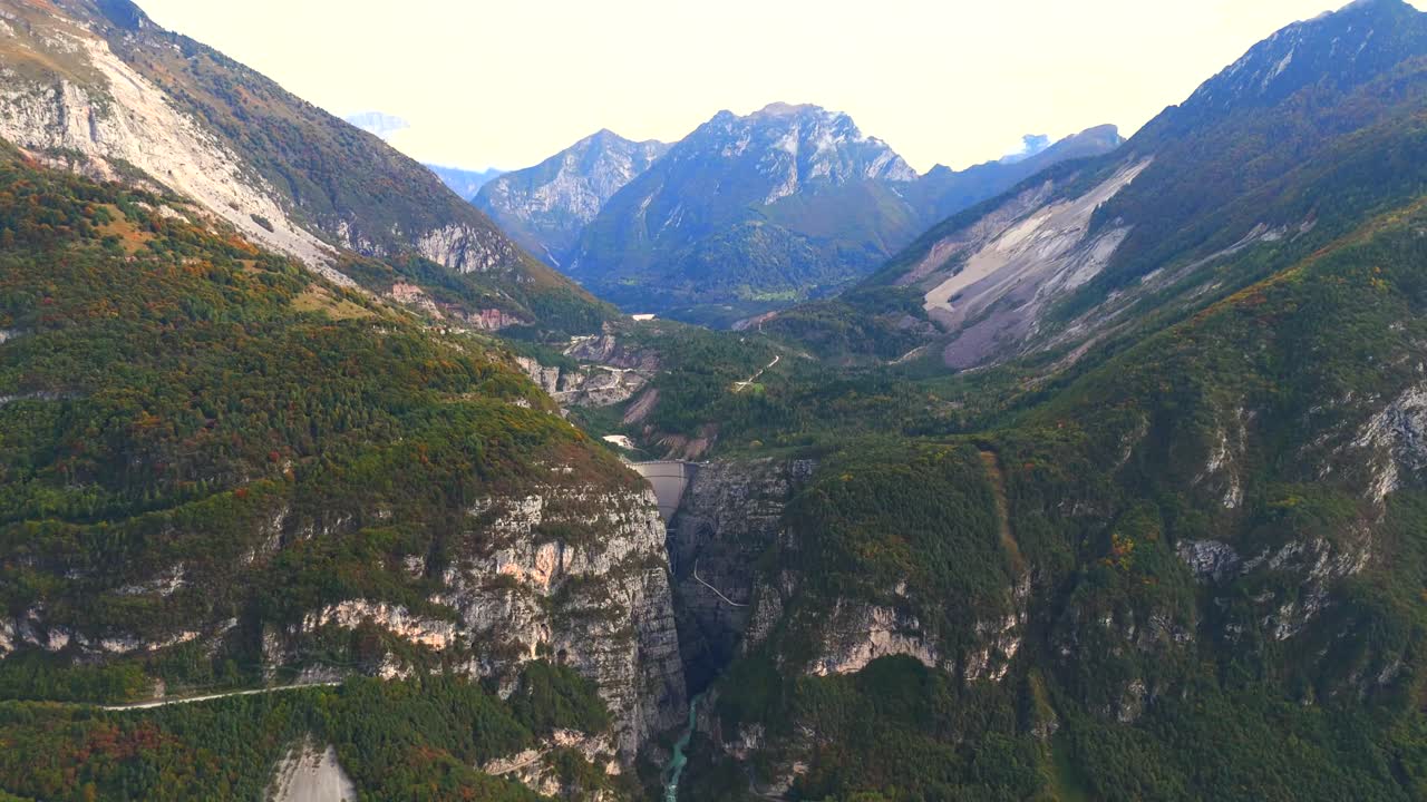 The impressive Vajont Dam seen from above, surrounded by steep cliffs.